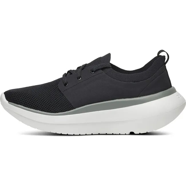 Medial side of Men&#39;s OOfos OOmy Stride Shoe in black and white