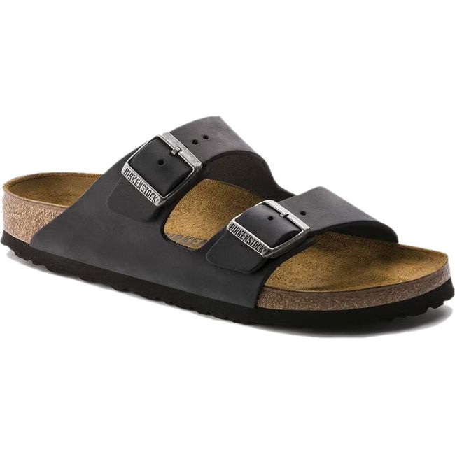 Angled side view of a black Birkenstock Arizona sandal with cork footbed and two adjustable straps.