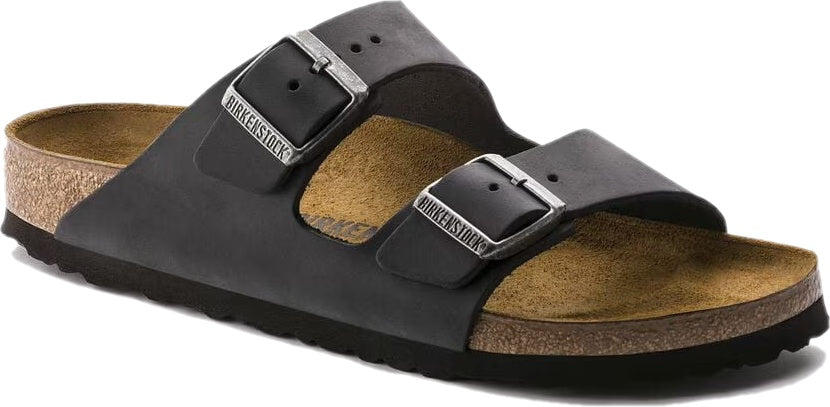 Angled side view of a black Birkenstock Arizona sandal with cork footbed and two adjustable straps.