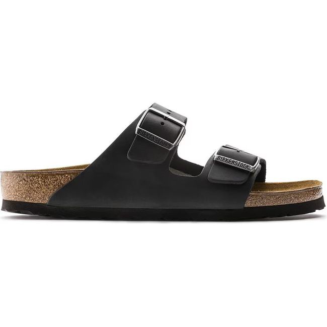 Side view of a black leather Birkenstock Arizona sandal with cork footbed and two adjustable straps.