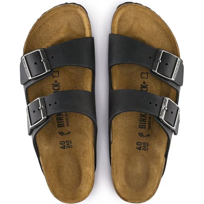 Top-down view of a pair of of black Birkenstock Arizona sandals with suede wrapped cork footbeds.