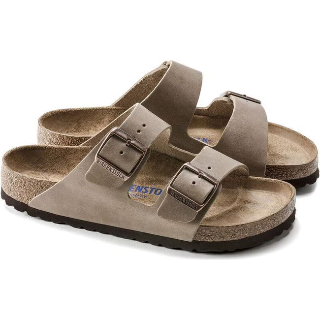Pair of Tobacco brown Birkenstock Arizona Soft Footbed Sandals with two straps and cork footbeds