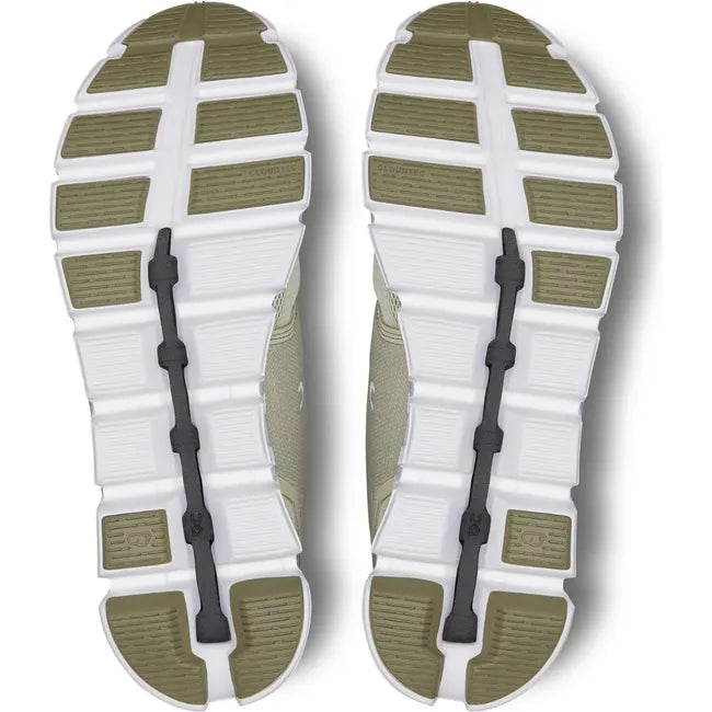 Soles of On Cloud 5 running shoes with a white sole and green tread sections near forefoot and heel