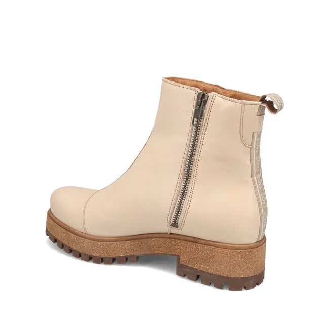 Angled Medial side of Women's Taos Downtown Boot in ivory leather with cork midsole and side zipper