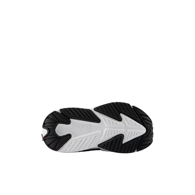 Sole of New Balance Kids' Rave run V2 top Strap Running Shoe (Infant/Toddler) in White and Black