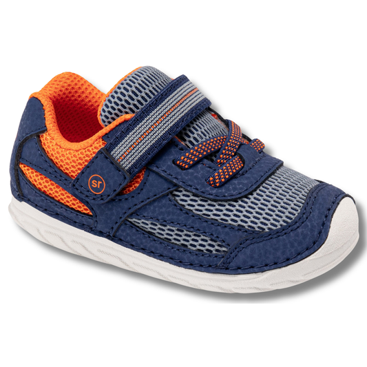 Angled side of Stride Rite Kids' Soft Motion Turbo 2.0 Sneaker in Navy Multi and Orange