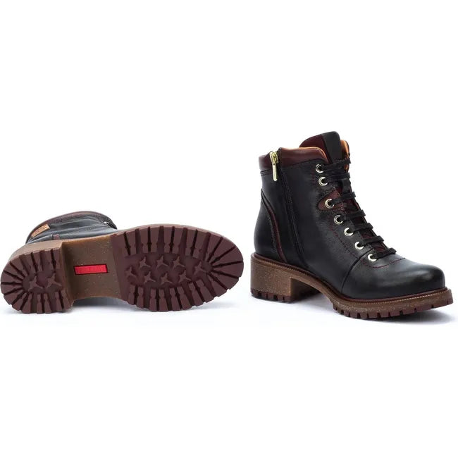 Pair of Women's Pikolinos Aspe Lace up Ankle Boot in black leather with one showing the rugged sole