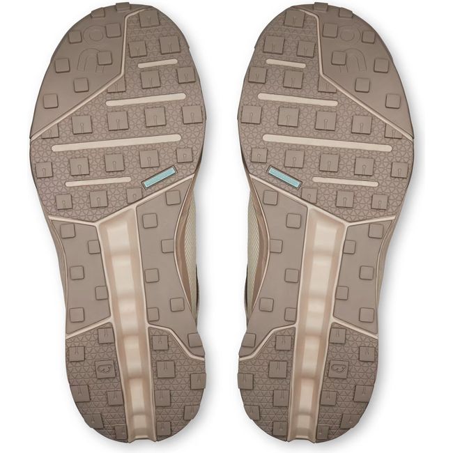 Soles of Women's On Running Cloudhorizon Trail Running Shoes in Ice Cream Beige with brown tread