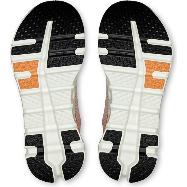 Soles of Women's On Running Cloudrunner 2 Running Shoes in Pearl Tangerine Orange with black tread