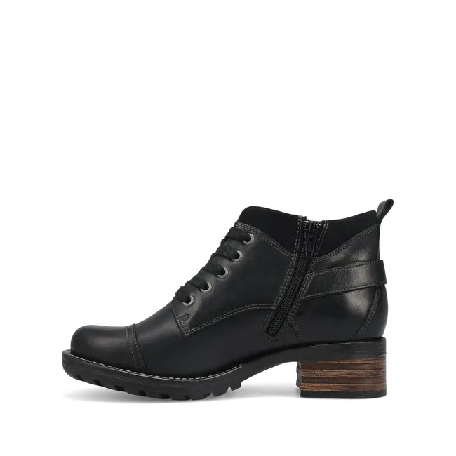 Medial side of Women's Taos Mini Crave Boot in black leather. Ankle height and lace up closure