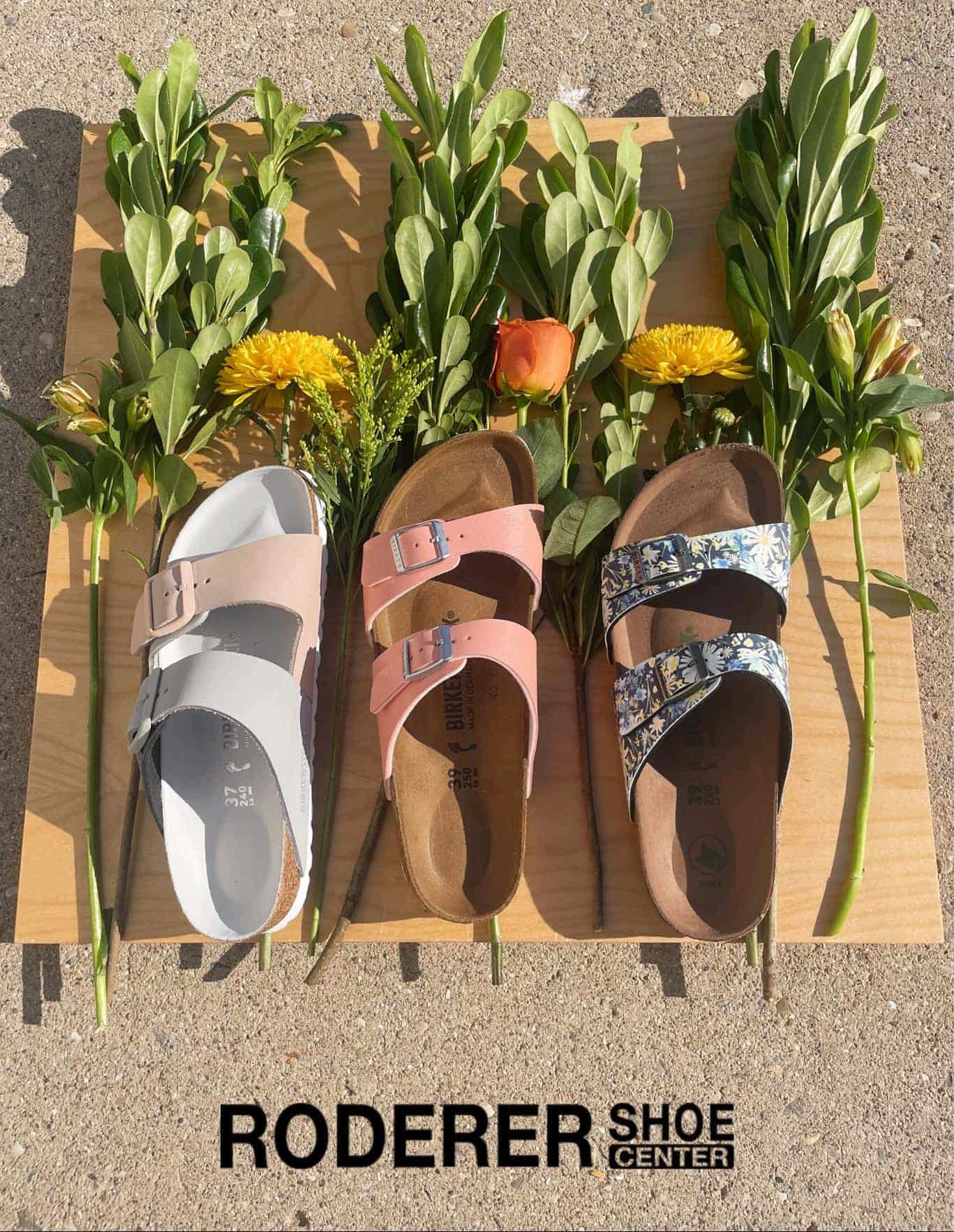Birkenstock Sandals on wooden table with flowers from Roderer Shoe Center