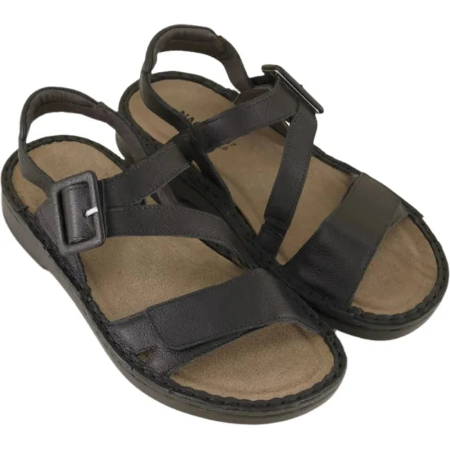 Overhead view of a pair of Naot Women's Castello Black Sandal featuring two hook and loop straps, faux buckle, a soft leather lining, removable suede footbed, and a 1.25-inch lightweight polyurethane sole.