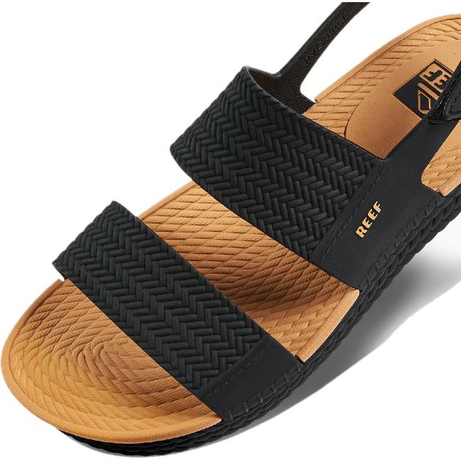 Close up of the front of Women's Reef Water Vista Sandal in black and tan with velcro backstrap