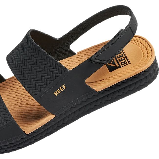 Close up of the heel of Women's Reef Water Vista Sandal in black and tan with velcro backstrap