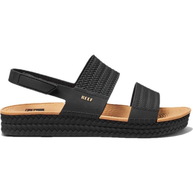 Lateral side of Women's Reef Water Vista Sandal in black and tan with velcro backstrap