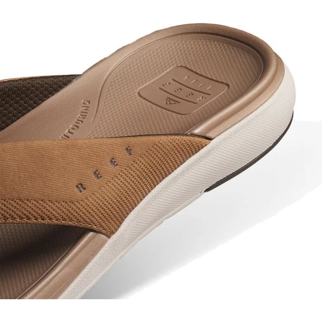 Heel close up of Men's Reef Cushion Norte Flip Flop in tan showing heel cup and cushion