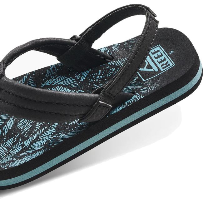 Heel close up of Kids Reef Little Ahi Sandal in Aquifer Palm black and blue with backstrap