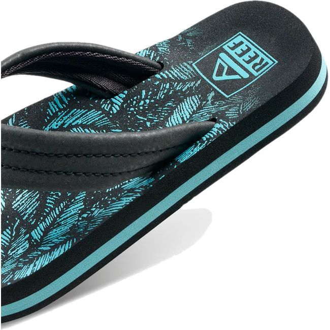 Close up of heel of Kids' Reef Ahi Flip Flop in Aquifer Palm black and blue