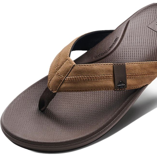 Close up view of the strap of Men's Reef Cushion Phantom 2.0 Flip Flop in Brown and Tan