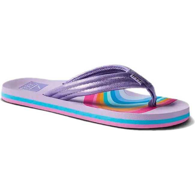 Front angled view of Kids' Reef Ahi Flip Flop in Candyland purple with rainbow patterns