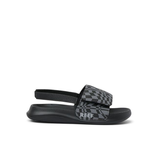 Lateral side of Kids' Reef Little Salty Slide in Black Swell Checker