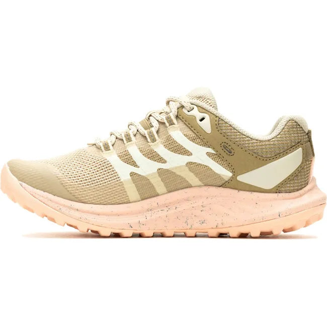 Medial side view of Merrell Women's Antora 3 Trail Running Shoe featuring a beige mesh and TPU upper, peach cushioned midsole, and Vibram TC5+ outsole with 4mm lugs for enhanced grip. Highlights the arch support.