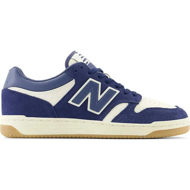 Lateral side of Unisex New Balance 480 sneakers in navy blue and off-white with a gum sole.