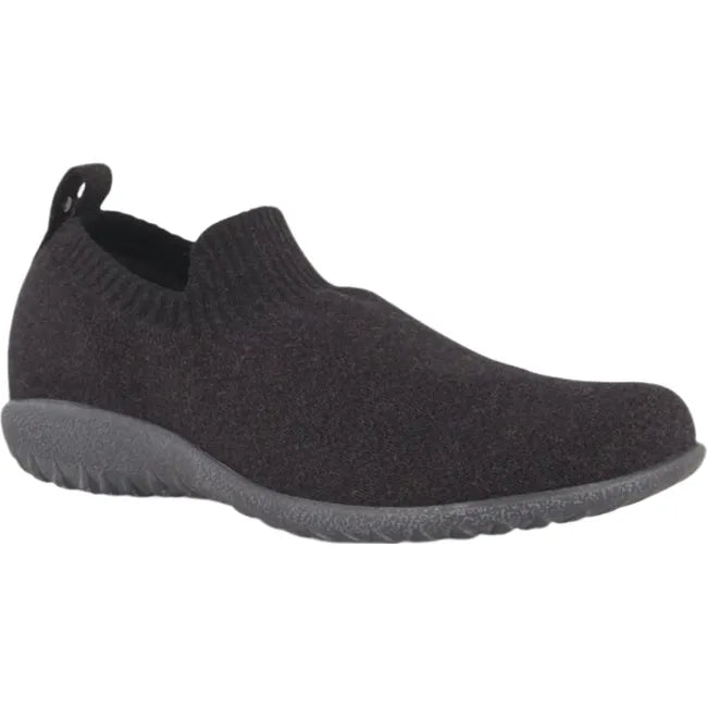 Lateral side angled view of Naot Women's Nuku Slip-On Shoe in black vegan material, featuring a breathable knit upper, padded heel for comfort, and a 1-inch slip-resistant polyurethane sole.