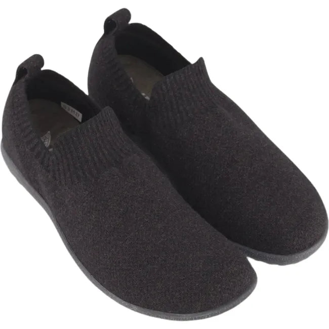 Overhead view of a pair of Naot Women's Nuku Slip-On Shoes in black vegan material, featuring a flexible knit upper and cushioned footbeds.