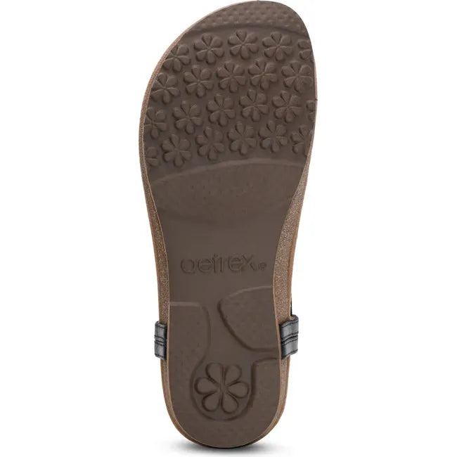 Brown sole of Womens Aetrex Evelyn arch Support Thong Sandal in Black leather upper