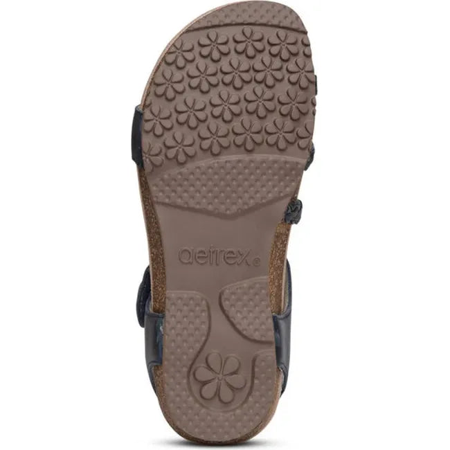 Brown sole of Women's Aetrex Jillian Arch Support Sandal in Navy blue upper