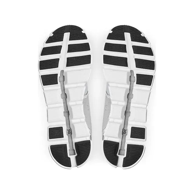 Soles of On Cloud 5 Waterproof running shoe with a white sole and black tread near forefoot and heel