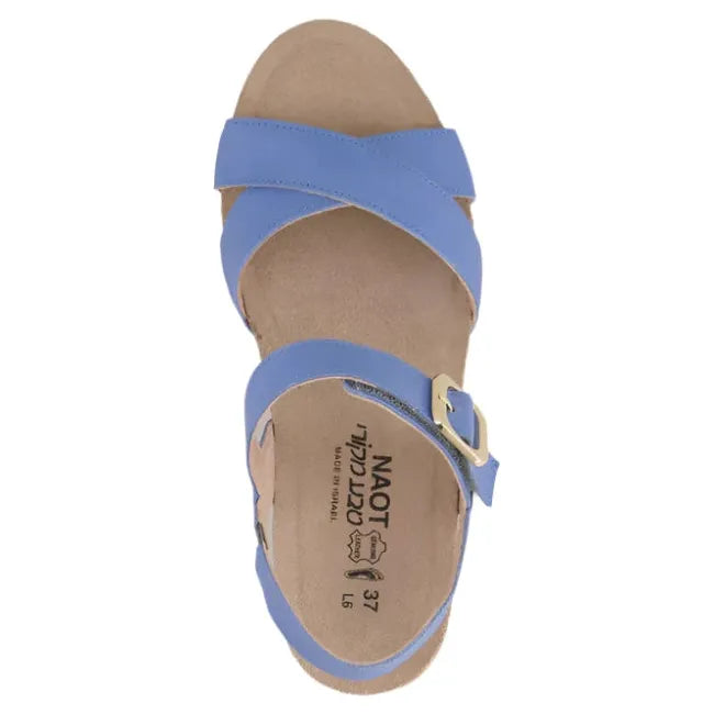 Top view of a single Naot Women's Throne Wedge Sandal in sapphire blue leather, showcasing the hook-and-loop Velcro strap at the ankle, 1.75-inch polyurethane wedge sole, and the tan suede wrapped footbed.