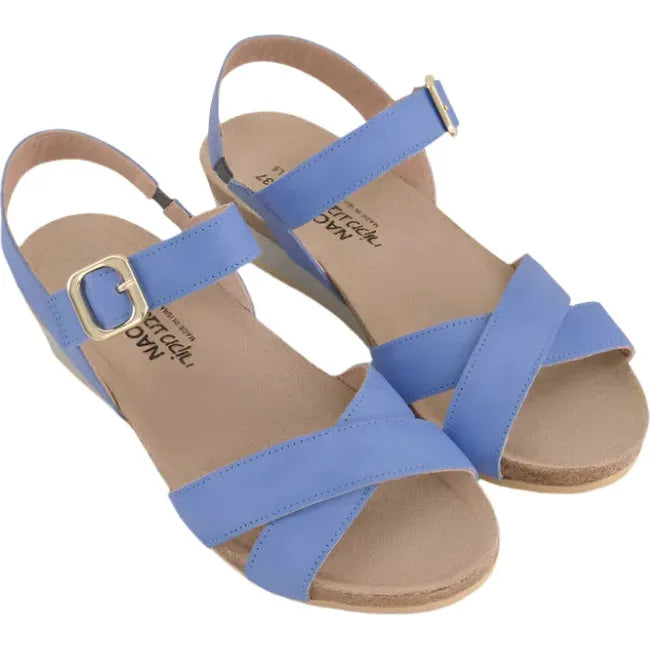 Overhead view of a pair of Naot Women's Throne Wedge Sandals in sapphire blue leather, featuring a hook-and-loop Velcro strap at the ankle, along with 1.75-inch polyurethane wedge soles and cork footbeds.