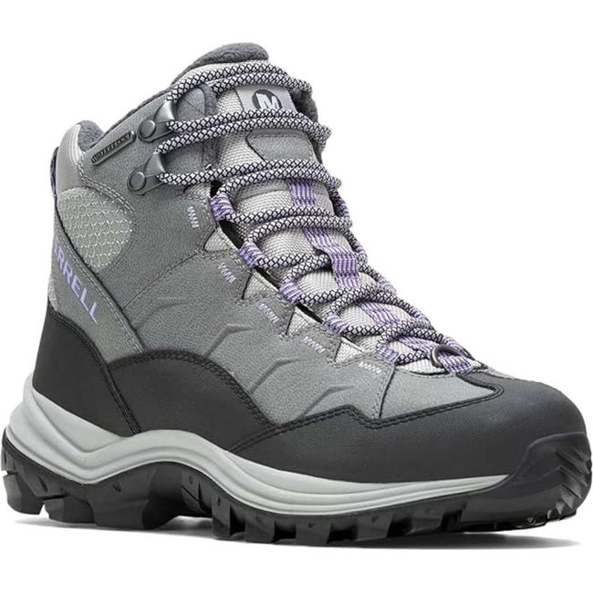 Front angled view of Merrell Women's Thermo Chill Mid Waterproof Hiking Boot showing gray waterproof leather upper, reinforced rubber toe cap, metal lace hooks, fleece lining, and rugged 5mm lug outsole for winter traction.
