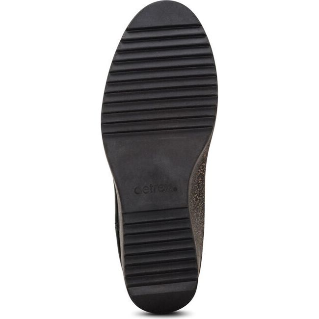 Sole of Women's Aetrex Dawn Wedge Boot in black leather with cork speckled sole and black tread