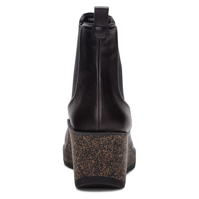Heel of Women's Aetrex Dawn Wedge Boot in black leather with cork speckled sole