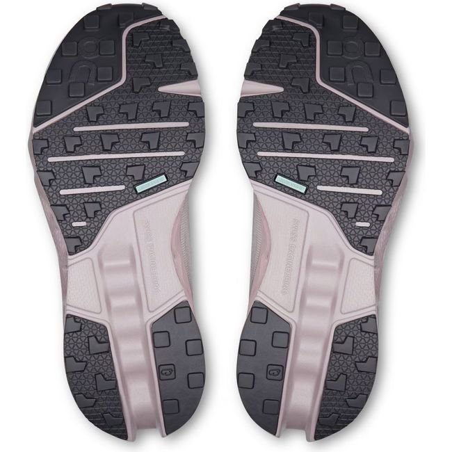 Soles of Women's On Running Cloudsurfer Trail Running Shoes in Silver and Mauve with black tread