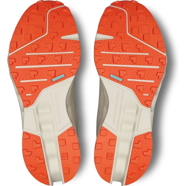 Soles of Men's On Running Cloudsurfer Trail Running Shoes in Fossil Ivory with orange tread