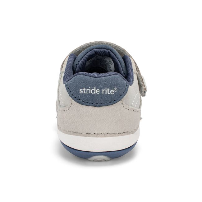 Rear heel view of the Stride Rite Artie in stone grey with a deep navy heel