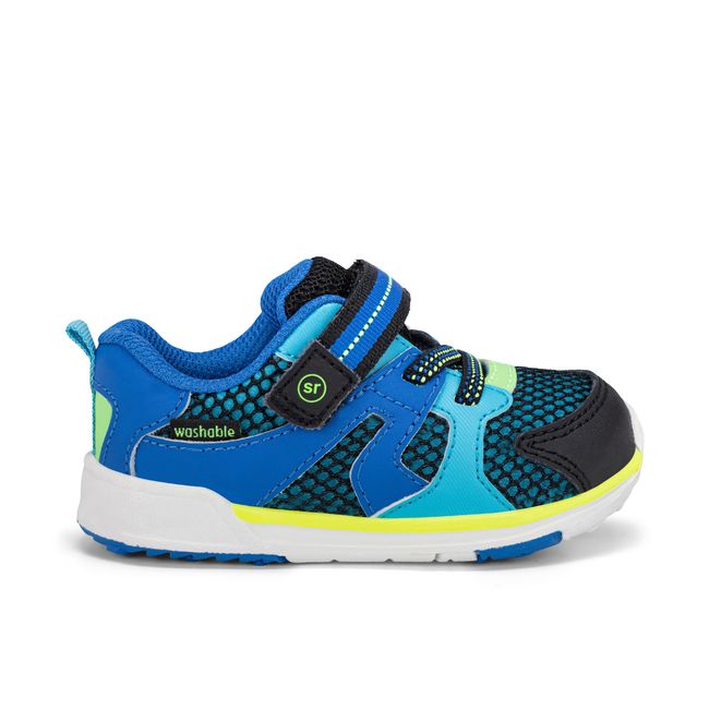 Right side profile of the Stride Rite Velocity in black and royal blue with a white sole