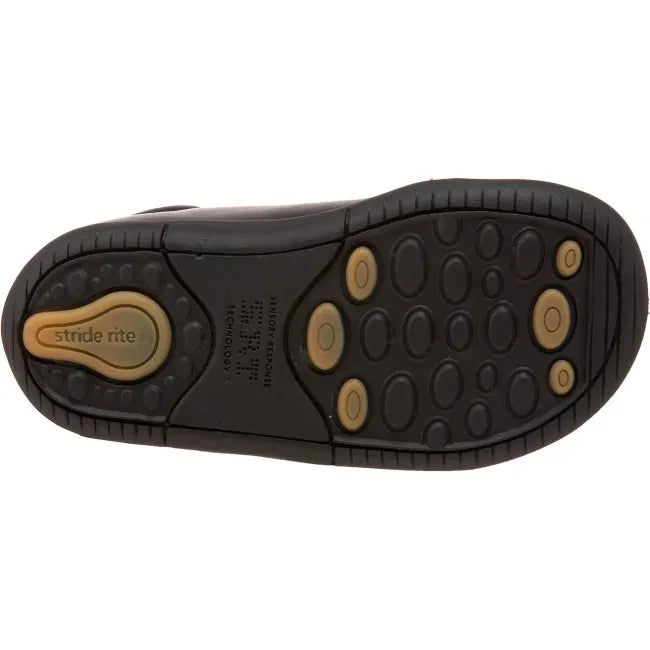 Outsole of the Stride Rite Elliot first walker shoe in jet black showing the traction pattern