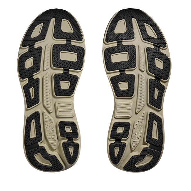 Soles of Hoka Men's Bondi 9 Running Shoe in Grassland