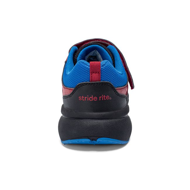 Rear heel view of the Stride Rite Equilibrium in black with a bright red heel