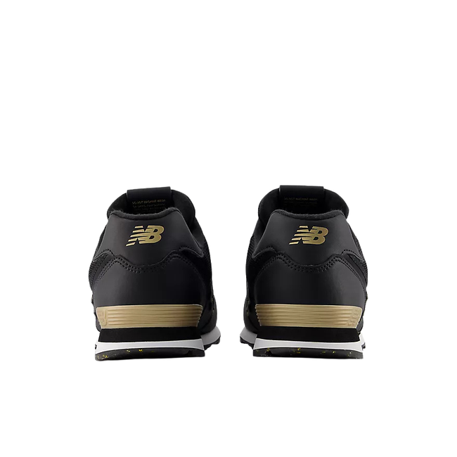 Heels of New Balance Kids' 574 Lifestyle Shoe (Youth) in Black with gold