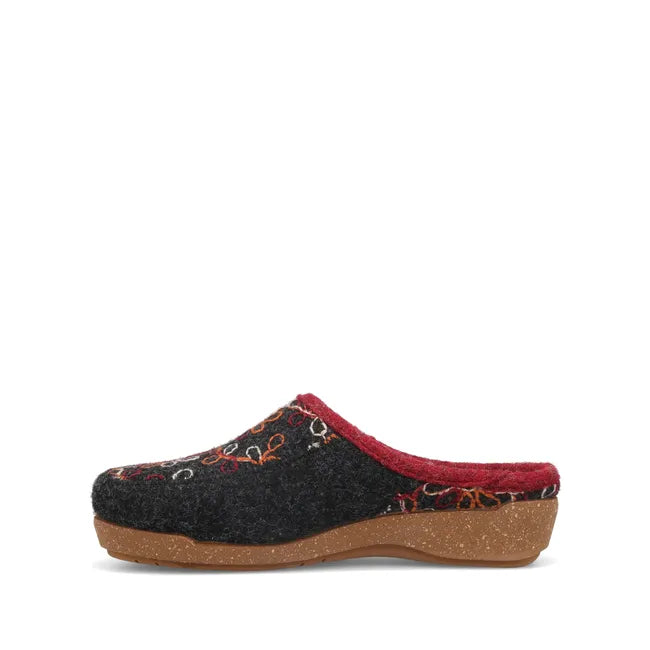 Medial side of Womens Taos Woolflower Slipper in charcoal wool. Red accents and tan footbed