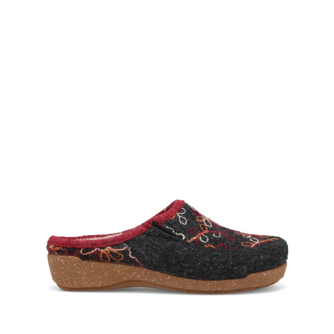 Lateral side of Womens Taos Woolflower Slipper in charcoal wool. Red accents and tan footbed