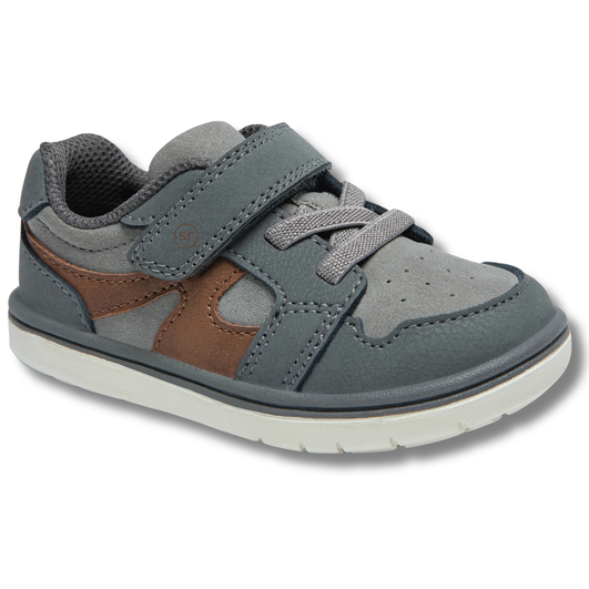 Angled view of Stride Rite Kids' London Sneaker in Grey with adjustable velcro strap