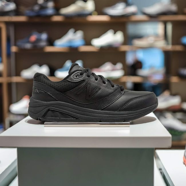 New Balance 928 Men's Stability Walking Shoe with Rollbar in Black leather on display in store
