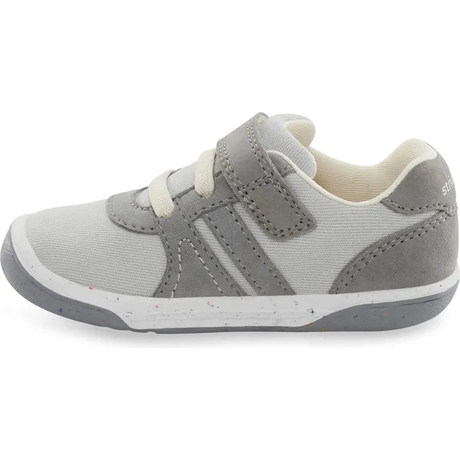 Medial side of Kids Stride Rite Fern Sneaker in gray and light gray with a velcro strap